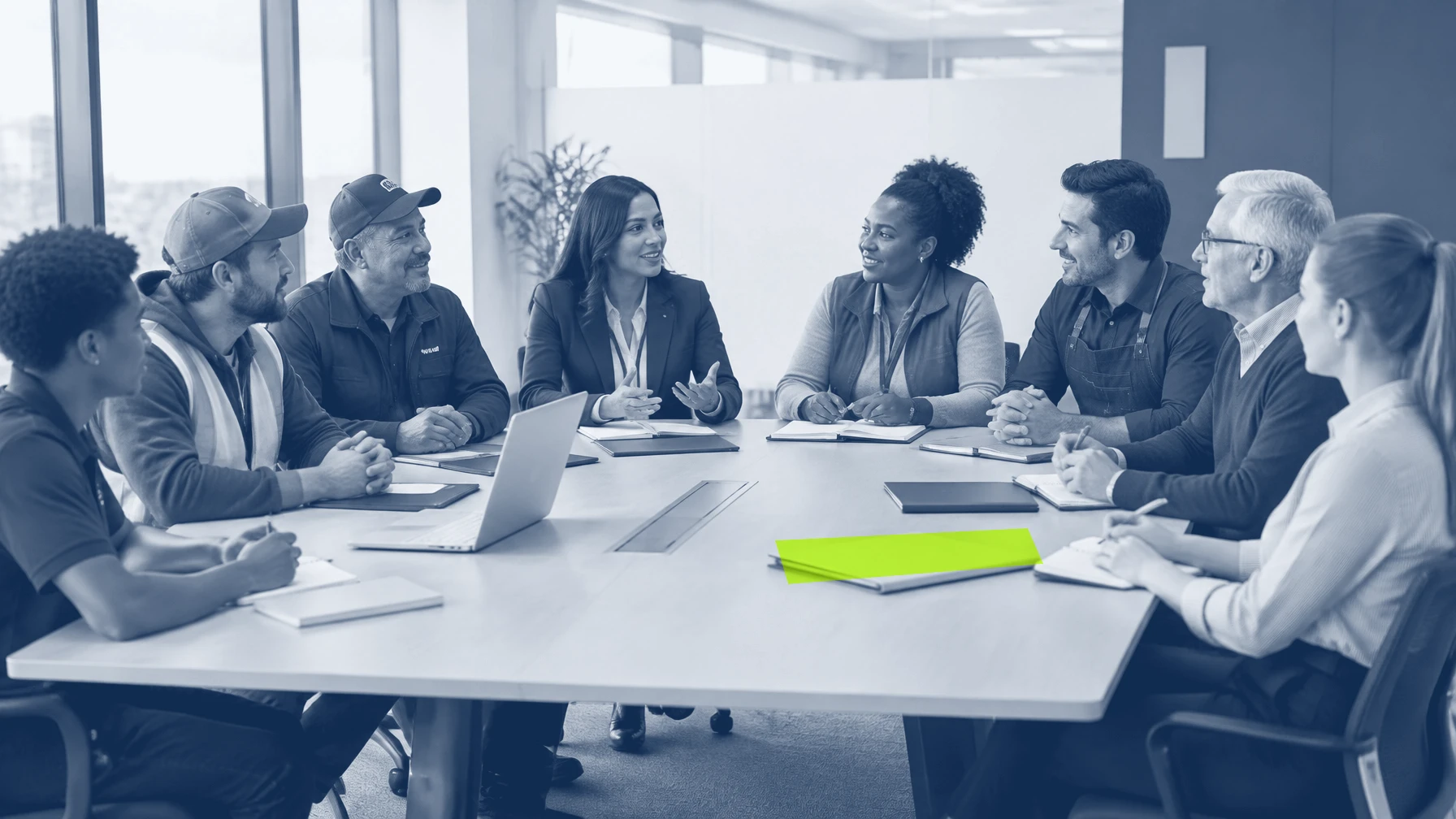 Eight diverse small-business teammates discussing health benefits around a conference table